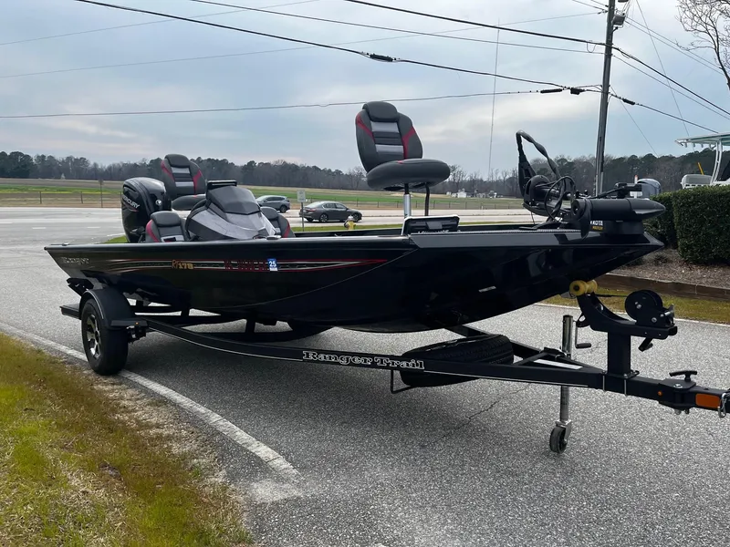Slide: The Image of 2021 Ranger RT178 boat on trailer, parked on roadside, overcast sky. - 4