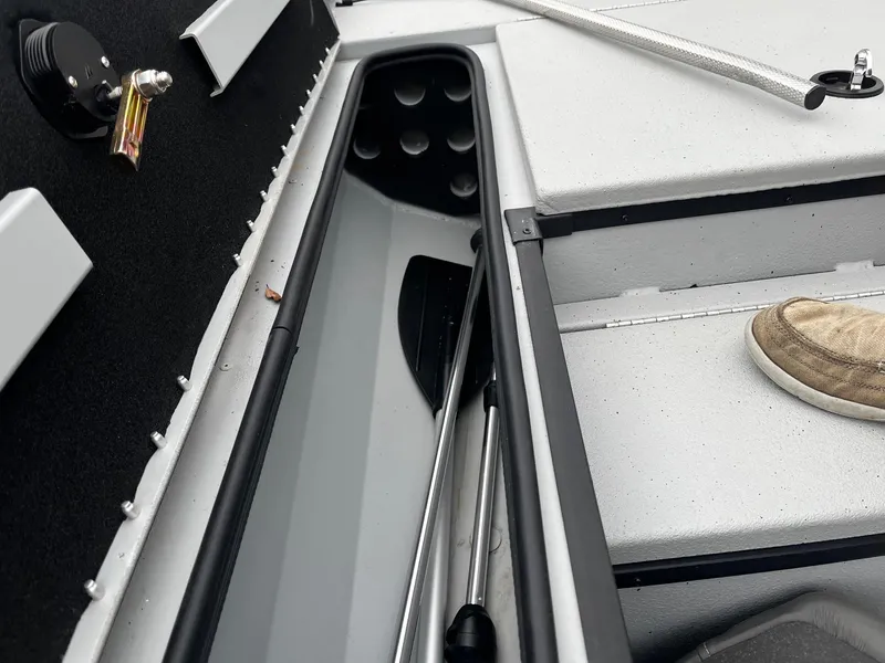 Slide: The Image of Interior of a 2021 Ranger RT178 boat showing storage compartment and paddle. - 8