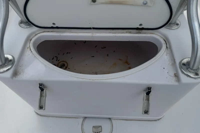 Slide: The Image of Open storage compartment on a 2002 Pro-Line 20 Sport boat, showing interior details. - 12