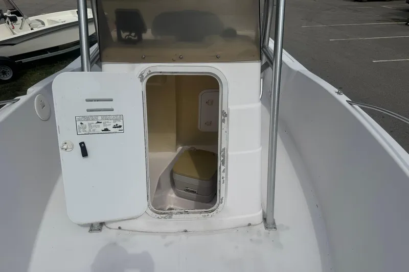 Slide: The Image of 2002 Pro-Line 20 Sport boat with open storage compartment and portable toilet. - 14