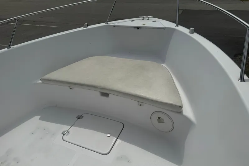 Slide: The Image of 2002 Pro-Line 20 Sport boat interior with cushioned seating and storage compartment. - 15