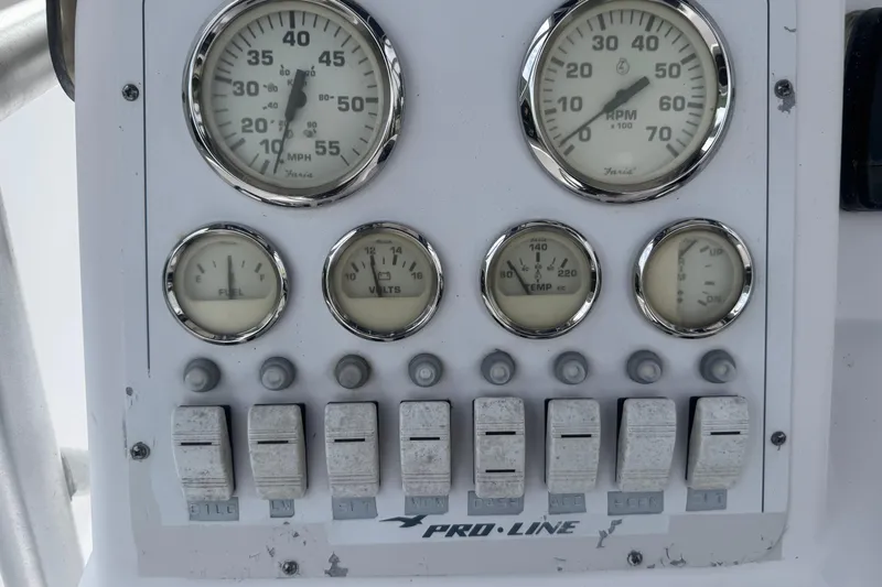 Slide: The Image of Dashboard of a 2002 Pro-Line 20 Sport boat with gauges and switches. - 9