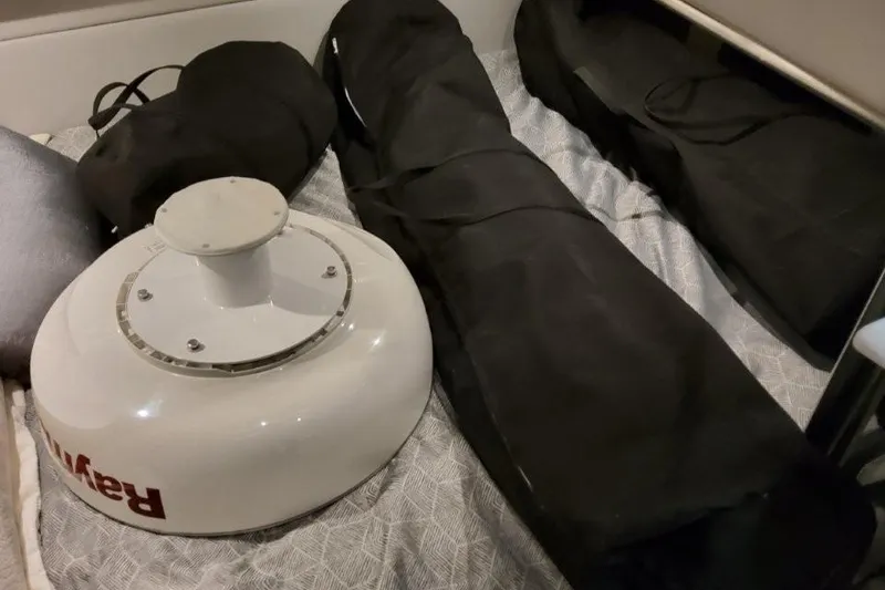 Slide: The Image of 2026 Formula 380 Super Sport Crossover OB equipment with Raymarine radar and black storage bags. - 106