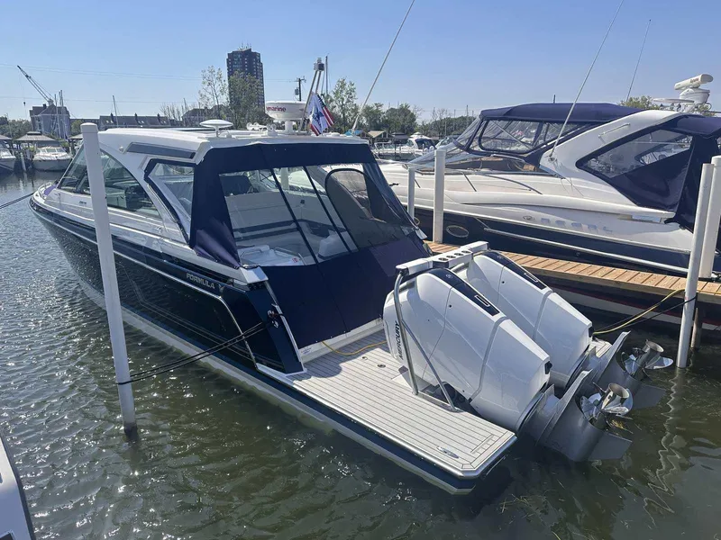 Slide: The Image of 2026 Formula 380 Super Sport Crossover OB boat in a showroom setting. - 2