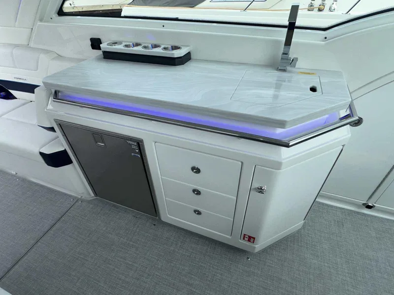 Slide: The Image of 2026 Formula 380 Super Sport Crossover OB interior with white seating and cup holders. - 27