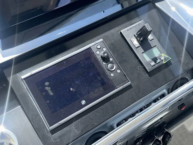 Slide: The Image of 2026 Formula 380 Super Sport Crossover OB boat interior with white seating and cup holders. - 39