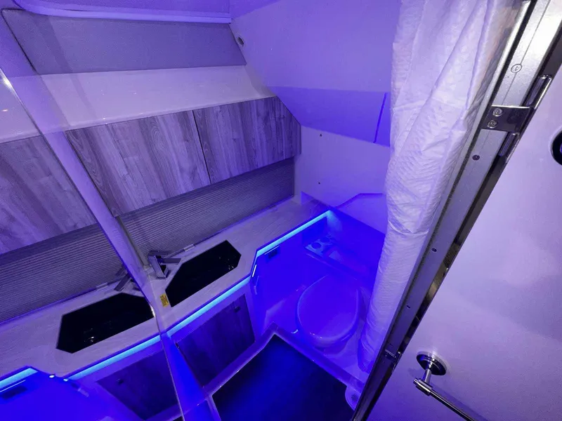 Slide: The Image of 2026 Formula 380 Super Sport Crossover OB boat seating with cup holders and sleek design. - 73