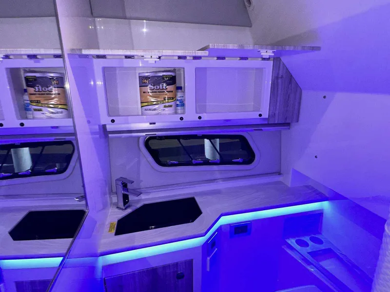 Slide: The Image of 2026 Formula 380 Super Sport Crossover OB boat interior seating, featuring luxurious white upholstery. - 74