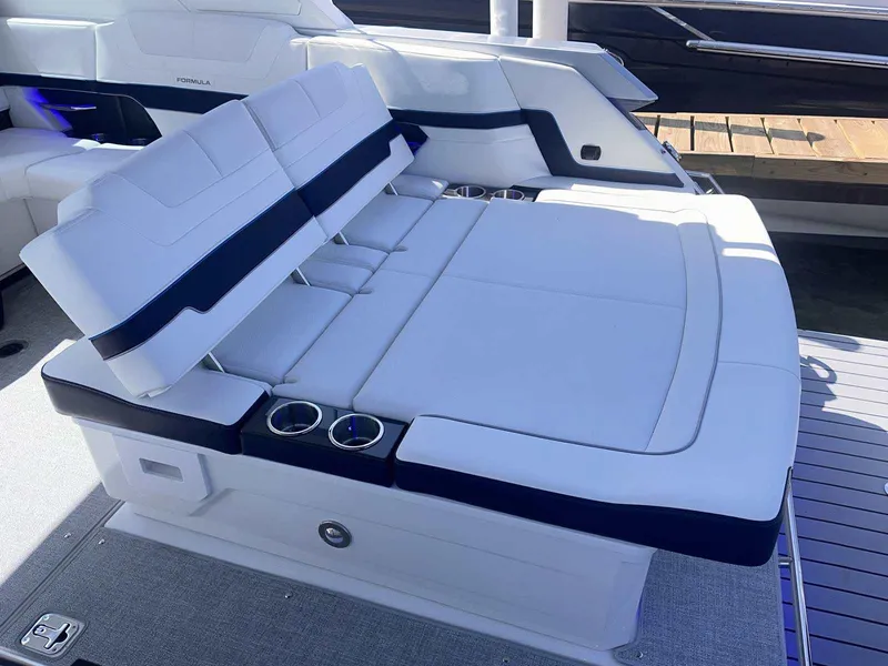 Slide: The Image of 2026 Formula 380 Super Sport Crossover OB boat in a showroom, rear view. - 8