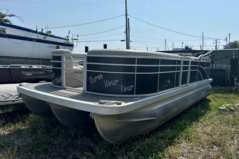 Slide: The Image of 2019 Bennington 21 SLX pontoon boat parked on grass, labeled "Three Hour Tour." - 10