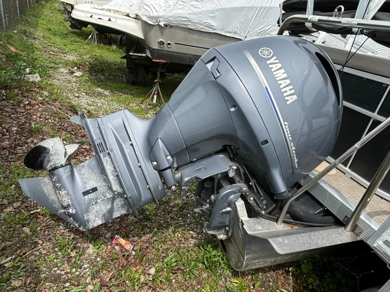 Slide: The Image of 2019 Bennington 21 SLX with Yamaha outboard motor, parked on grass. - 3