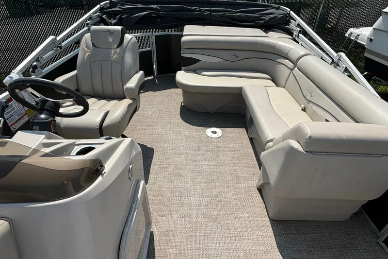 Slide: The Image of 2019 Bennington 21 SLX pontoon boat interior with plush seating and steering console. - 5