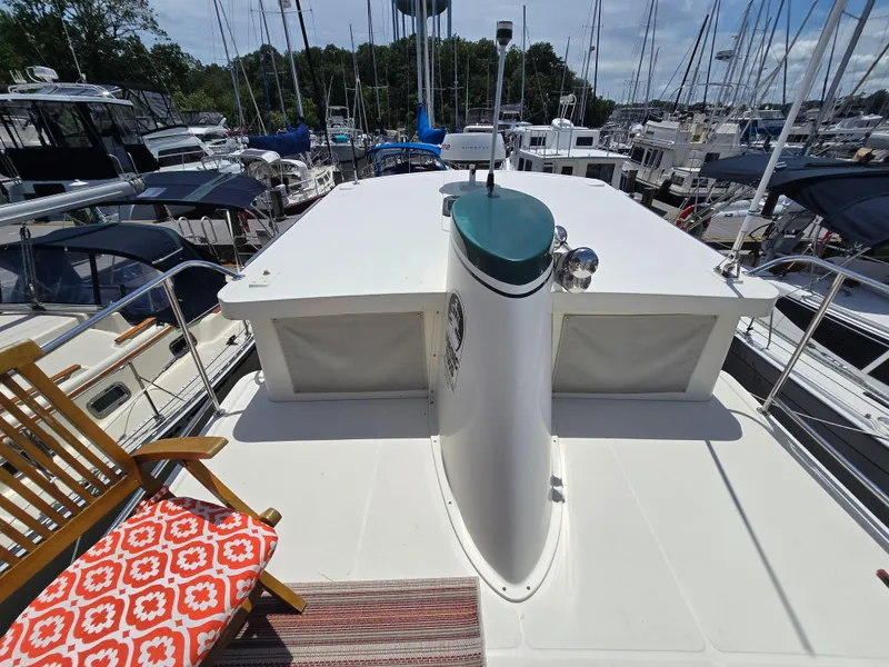 Slide: The Image of Nordic Tug 32 (2001) boat deck with chair, docked in marina. - 24