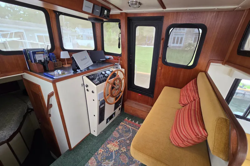 Slide: The Image of Interior of a 2001 Nordic Tug 32 with helm, seating, and navigation equipment. - 3