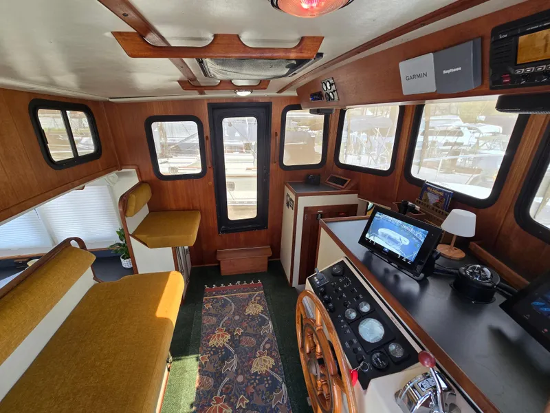 Slide: The Image of Interior of 2001 Nordic Tug 32 with helm, seating, and navigation equipment. - 5