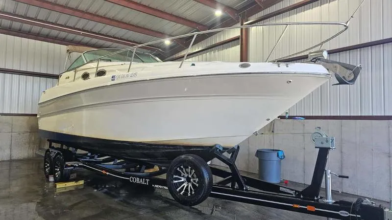 Slide: The Image of 1999 Sea Ray 270 boat on trailer in indoor storage facility. - 5