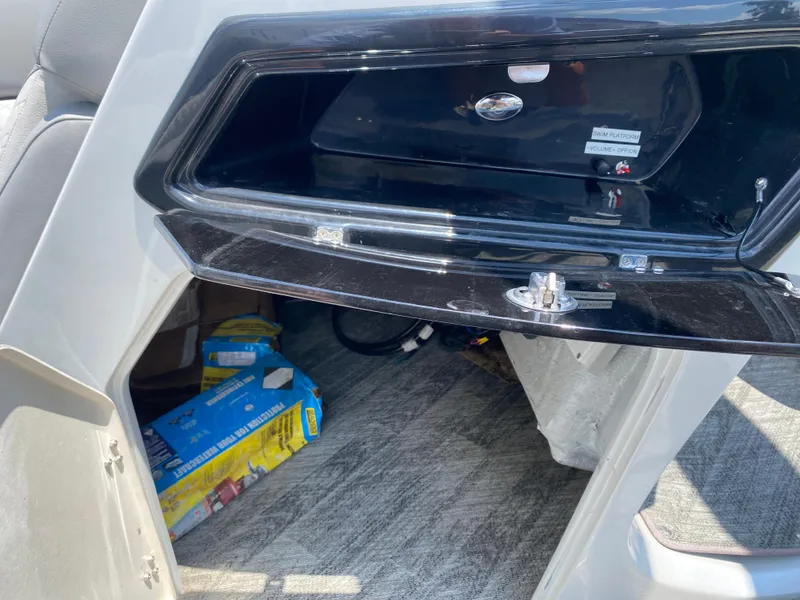 Slide: The Image of Open storage compartment in a 2020 Manitou 25 Legacy SHP DL boat. - 15