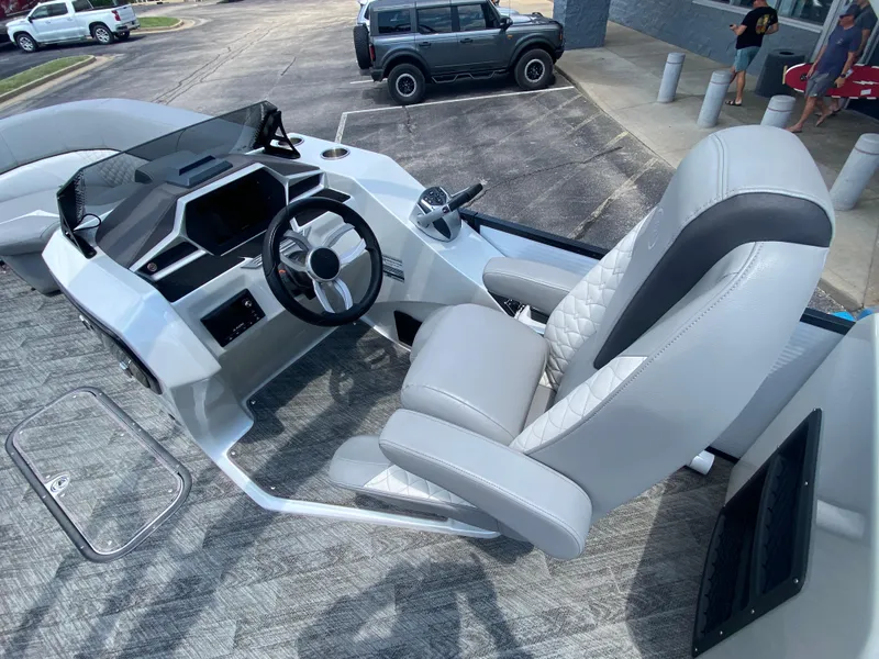 Slide: The Image of 2020 Manitou 25 Legacy SHP DL boat interior with modern helm and luxurious seating. - 17