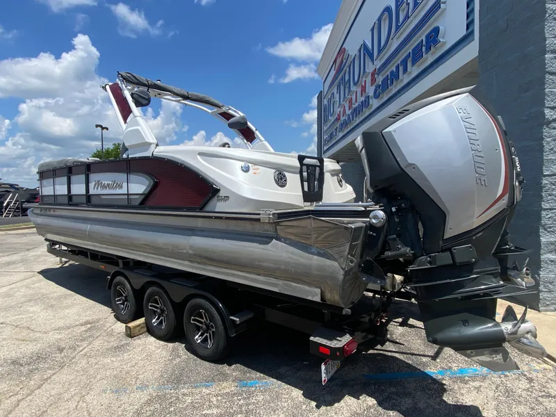 Slide: The Image of 2020 Manitou 25 Legacy SHP DL pontoon boat with Evinrude engine at dealership. - 2