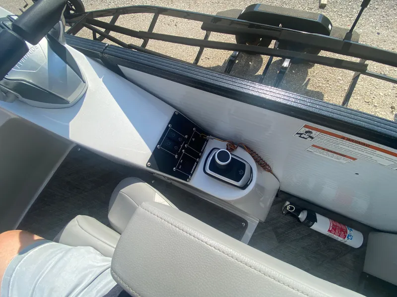 Slide: The Image of 2020 Manitou 25 Legacy SHP DL boat interior with control panel and fire extinguisher. - 24