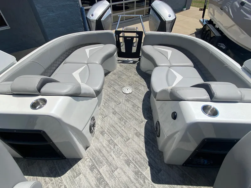 Slide: The Image of 2020 Manitou 25 Legacy SHP DL boat interior with gray seating and cup holders. - 25