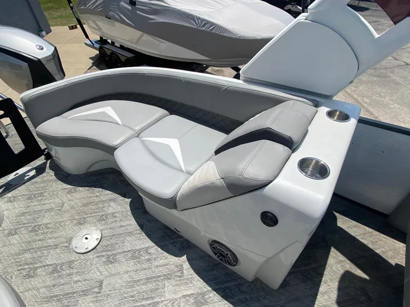Slide: The Image of 2020 Manitou 25 Legacy SHP DL boat interior with gray seating and cup holders. - 27