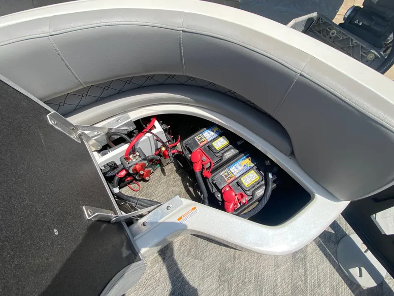 Slide: The Image of 2020 Manitou 25 Legacy SHP DL boat battery compartment with dual batteries and wiring. - 28