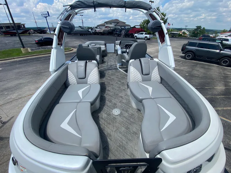 Slide: The Image of 2020 Manitou 25 Legacy SHP DL pontoon boat with luxurious seating and modern design. - 30