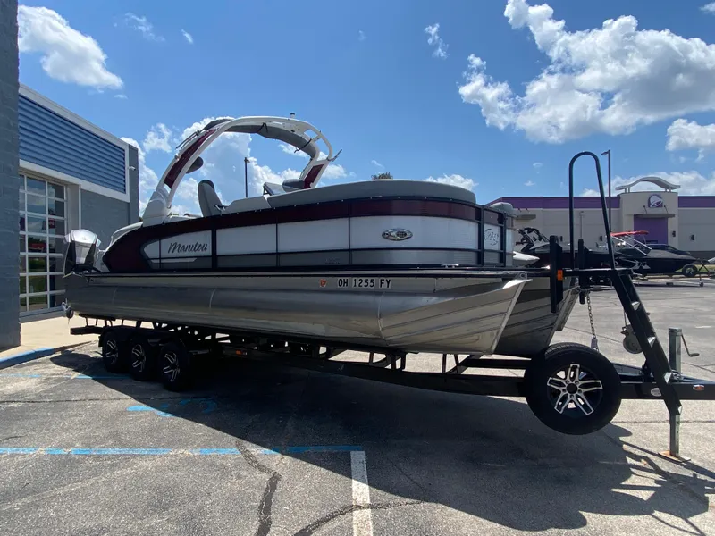 Slide: The Image of 2020 Manitou 25 Legacy SHP DL pontoon boat on trailer, parked outdoors. - 6