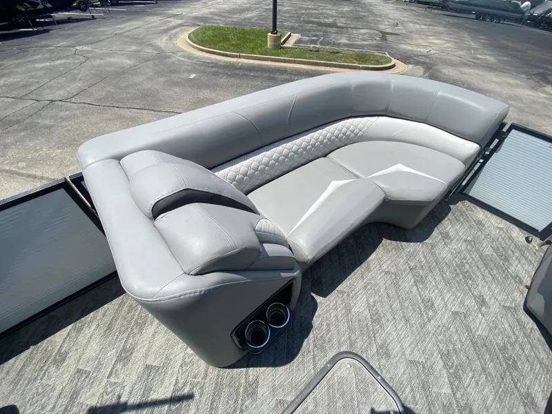Slide: The Image of Luxurious seating on 2020 Manitou 25 Legacy SHP DL pontoon boat, featuring sleek gray upholstery. - 9