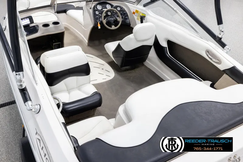 Slide: The Image of Interior of 2002 Tahoe Q3 I/O boat with white and black seating, dashboard, and steering wheel. - 10