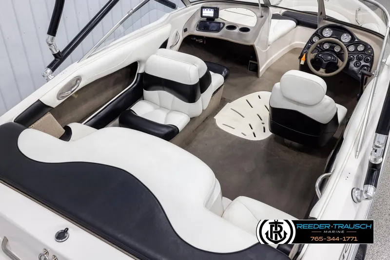Slide: The Image of 2002 Tahoe Q3 I/O Mechanical Special boat interior with white and black seating, steering console. - 11
