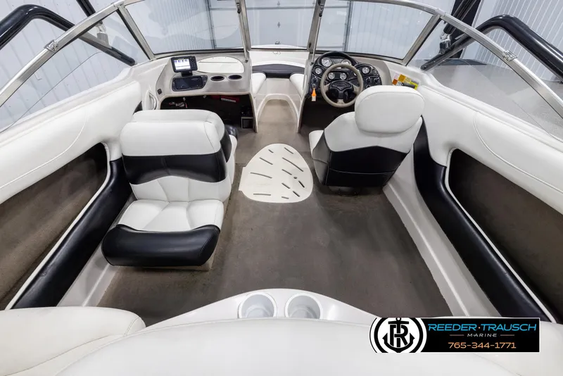 Slide: The Image of Interior of a 2002 Tahoe Q3 I/O Mechanical Special boat with white and black seating. - 12