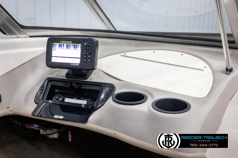 Slide: The Image of Dashboard of 2002 Tahoe Q3 I/O with Lowrance fishfinder and cup holders. - 19