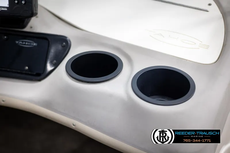 Slide: The Image of 2002 Tahoe Q3 I/O boat dashboard with cup holders and control panel. - 22