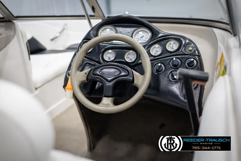 Slide: The Image of 2002 Tahoe Q3 I/O Mechanical Special boat dashboard with steering wheel and gauges. - 23