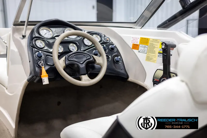Slide: The Image of Interior of a 2002 Tahoe Q3 I/O Mechanical Special boat, featuring steering wheel and controls. - 24