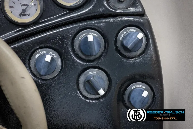 Slide: The Image of Control panel of a 2002 Tahoe Q3 I/O MECANICAL SPECIAL boat with various switches. - 31