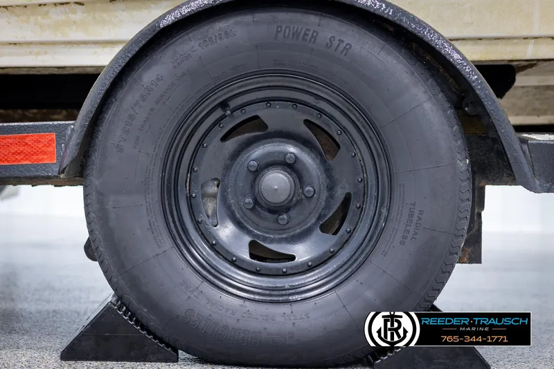 Slide: The Image of Close-up of a black tire on a 2002 Tahoe Q3 I/O Mechanical Special trailer. - 48