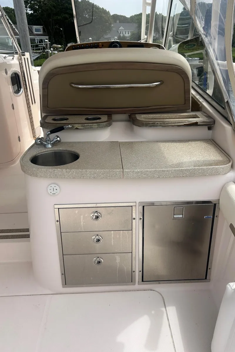 Slide: The Image of 2013 Grady-White Freedom 335 boat interior with seating and kitchenette. - 13