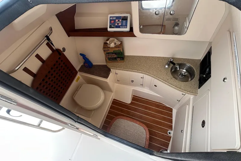 Slide: The Image of 2013 Grady-White Freedom 335 boat interior with sink, storage drawers, and countertop. - 14