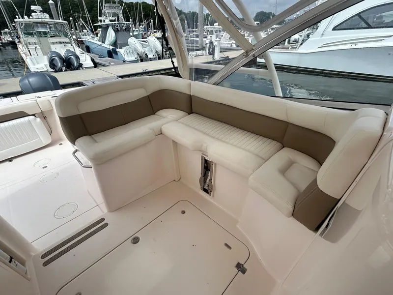 Slide: The Image of 2013 Grady-White Freedom 335 boat helm with steering wheel and control panel. - 17
