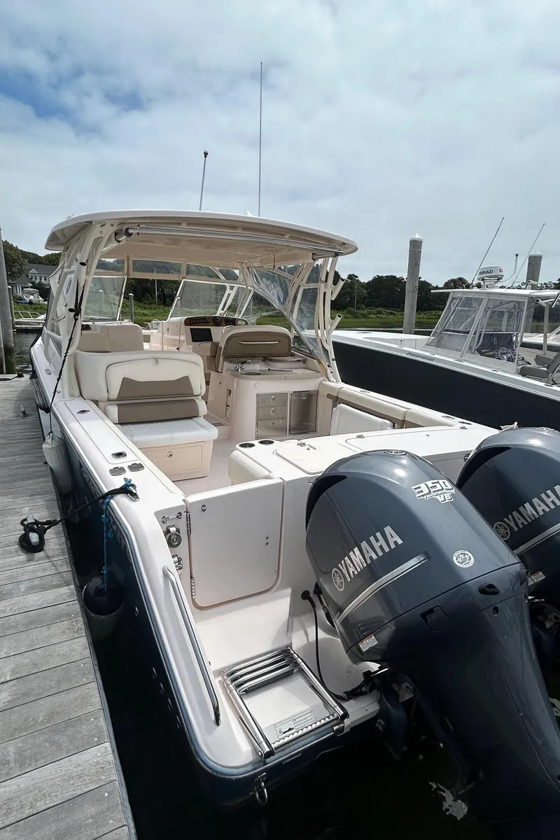 Slide: The Image of 2013 Grady-White Freedom 335 boat with twin Yamaha engines docked in a marina. - 19