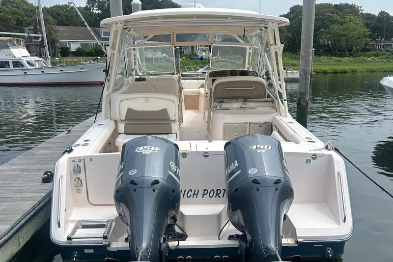 Slide: The Image of 2013 Grady-White Freedom 335 boat with twin Yamaha 350 engines docked at marina. - 20