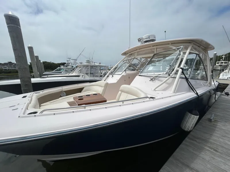 Slide: The Image of 2013 Grady-White Freedom 335 boat docked with Yamaha engines, calm water background. - 4