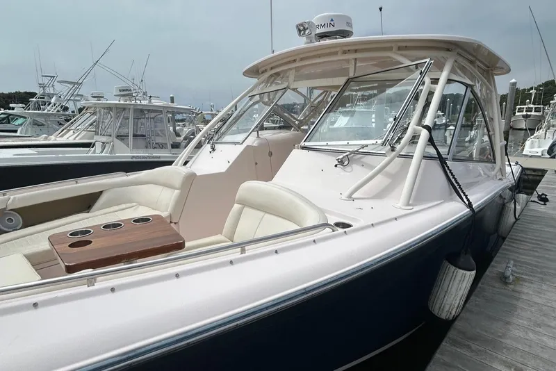 Slide: The Image of 2013 Grady-White Freedom 335 boat with spacious seating and sleek design docked at marina. - 8