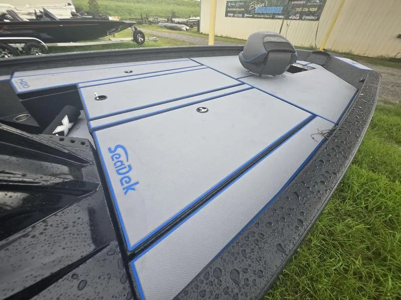 Slide: The Image of 2026 Xpress H20 Bass boat interior with dual seats and steering console. - 14