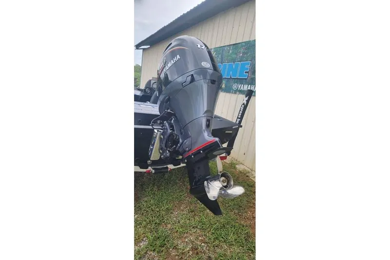 Slide: The Image of 2026 Xpress H20 Bass boat with Yamaha outboard motor, parked on grass. - 17
