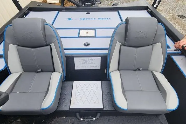 Slide: The Image of 2026 Xpress H20 Bass boat interior with two gray seats and blue accents. - 23