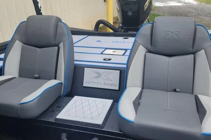 Slide: The Image of 2026 Xpress H20 Bass boat interior with gray and blue seating. - 24